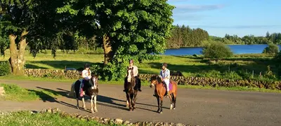 a group of people riding horses down a road at HV66 - FREE WIFI-3 Bedrooms Indoor Pool Loch Views Fishing Golf Riding Shooting Water Sports 15 Mins Drive To Beaches PASSES NOT INCLUDED Most Activities Will Not Be Available Out Of Season Please Check Before Booking in Newton Stewart