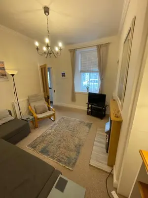a living room with a couch and a chair at Character cottage in centre of Moffat in Moffat