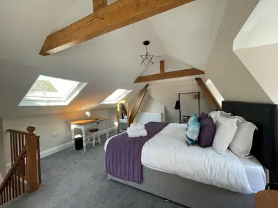 a bedroom with a king sized bed in a attic at Grisedale Pike in Keswick