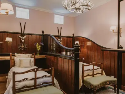 a bedroom with a bed and a chair and a chandelier at Fawn's Velvet in Enoch