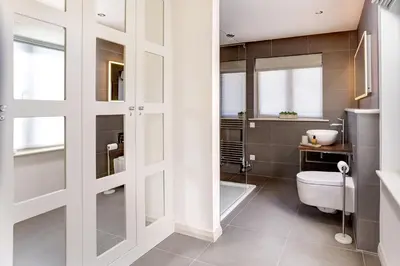 a bathroom with a toilet and a bath tub at Lowfield House in Ambleside