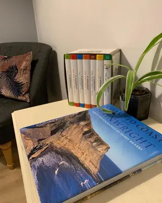 a table with three books on top of it at Mill Cottage modern cosy Lake District home with open fire near Scafell in Gosforth