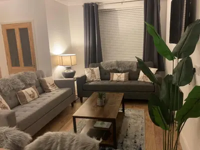 a living room with a couch and a coffee table at Marni’s Cottage - Rural location & fell views in Frizington
