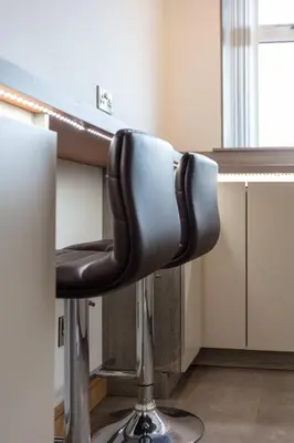 a black chair sitting at a desk in a room at West Sands - Donnini Apartments in Ayr