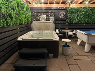 a jacuzzi tub in a room with a table at Bothy Farm Stay Sleeps 2 HotTub and Pool Table Children Welcome Ayrshire Rural Retreats in Newmilns