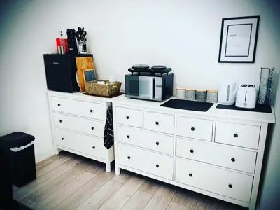 a white dresser with a microwave on top of it at The Sty & The Stable in Carlisle