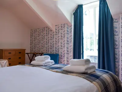 a bedroom with a bed with towels on it at Hey Down in Keswick