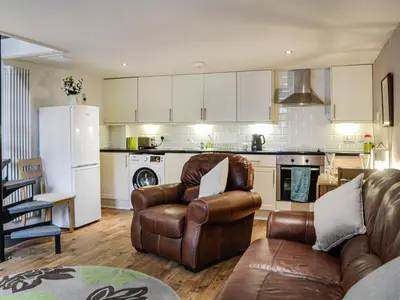 a living room with a couch and chairs in a kitchen at The Annex in Crosby