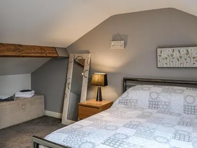 a bedroom with a bed and a lamp on a night stand at The Annex in Crosby