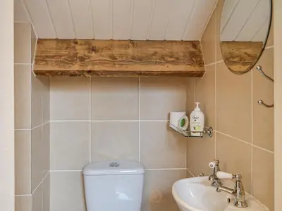 a bathroom with a toilet and a sink and a mirror at The Annex in Crosby
