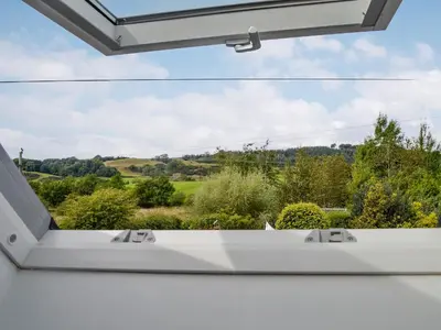 a window with a view of the countryside from a house at Kerrim Cottage in Ringford
