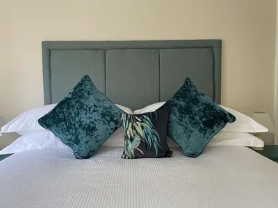 a bedroom with a bed with two pillows on it at Three Peaks in Braithwaite