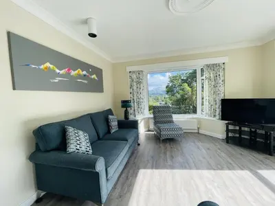 a living room with a couch and a television at Three Peaks in Braithwaite
