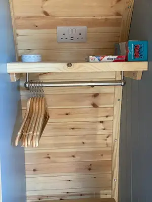 a wooden cabinet with wooden utensils on it at Craigend Farm Holiday Pods - The Woolly Sheep in Dumfries
