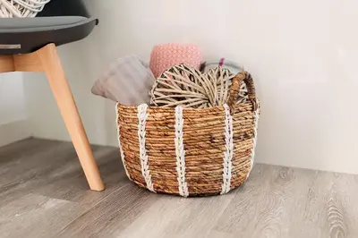 a basket sitting on the floor next to a chair at Sea Glass Lodge in Gatehouse of Fleet