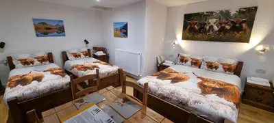 a room with two twin beds and a painting on the wall at Wastwater Cottage on The Big 