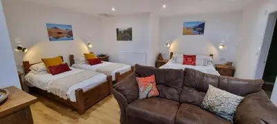 a living room with two beds and a couch at Wastwater Cottage on The Big 