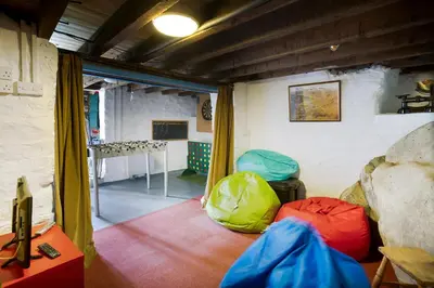 a room with two chairs and a table at Oak Cottage Chapel Stile in Chapel Stile