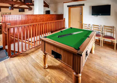 a pool table in the middle of a room at Lyons Manor House in Maryport