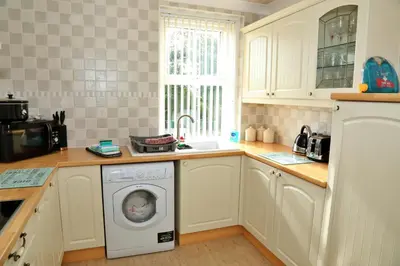 a kitchen with a washing machine in a kitchen at Finest Retreats - Glendale in Skinburness