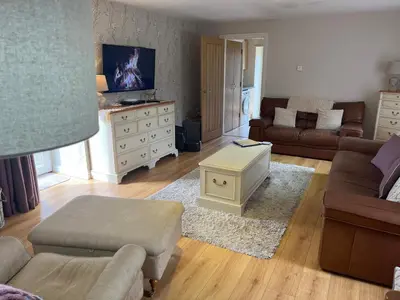 a living room with a couch and a table at The Dairy in Castle Douglas