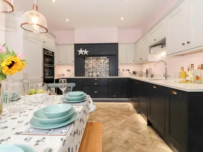 a kitchen with a table with blue dishes on it at Eller Close House in Ambleside