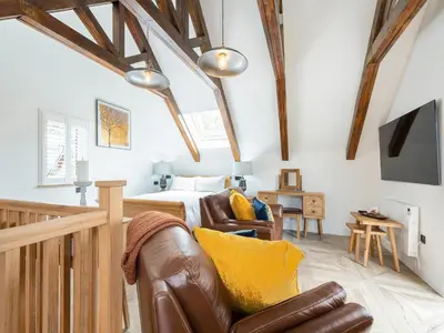 a living room with a bed and a couch at The Railway Sleeper in Hyndfordbridge-end