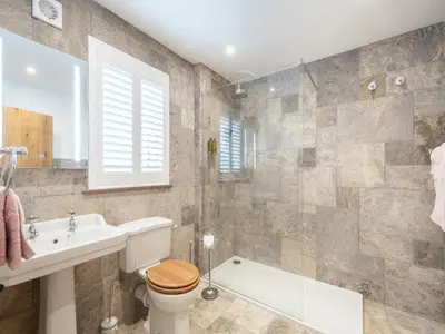 a bathroom with a toilet and a sink and a tub at The Railway Sleeper in Hyndfordbridge-end