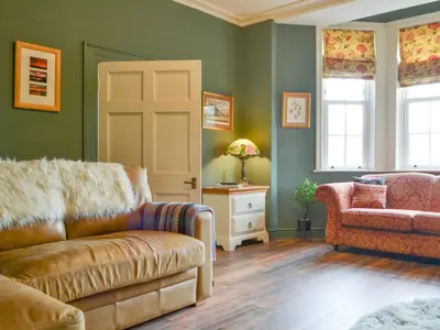 a living room with a couch and a chair at The Old Vicarage in Westward