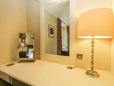 a lamp on a counter in a room with a mirror at Scale Force in Keswick