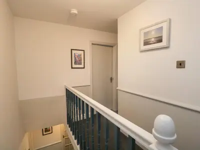 a staircase in a home with white walls at Ravenglass Retreat in Ravenglass