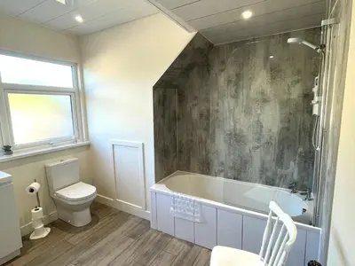 a bathroom with a bath tub and a toilet at Beautiful 5BR Rural Cottage with Outstanding Views - Pass the Keys in Castle Douglas