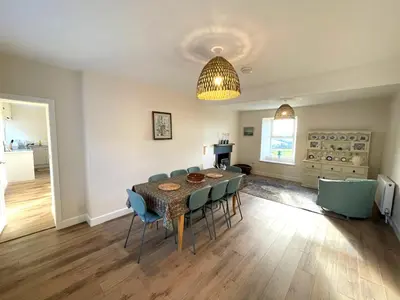 a dining room with a table and chairs at Beautiful 5BR Rural Cottage with Outstanding Views - Pass the Keys in Castle Douglas