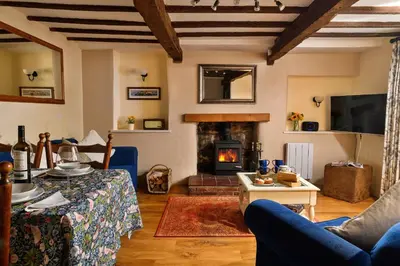 a living room with a couch and a fireplace at Finest Retreats - The Cottage at Greystoke in Greystoke