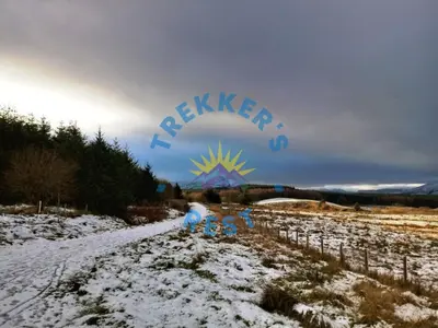 a snow covered field with a sign that reads relapse at Trekkers Rest, Brigham, Cockermouth, Cumbria in Cockermouth