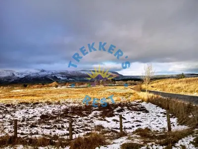 a snow covered field with a sign that says raigun at Trekkers Rest, Brigham, Cockermouth, Cumbria in Cockermouth