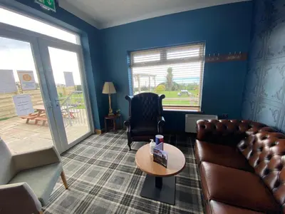 a living room with a couch and a chair and a table at The Calder House Hotel in Seascale