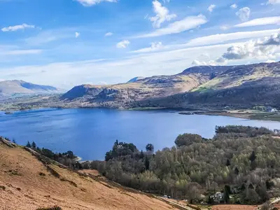 a view of a lake in the mountains at Howbeck Cottage in Hesket Newmarket