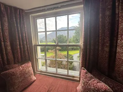 a window with a view of a mountain view at Seatoller House in Borrowdale Valley