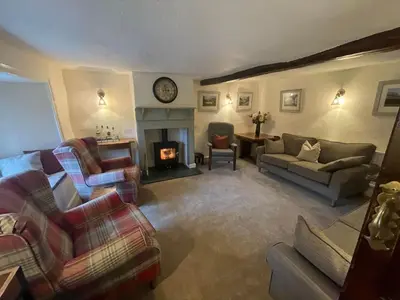 a living room filled with furniture and a fireplace at Seatoller House in Borrowdale Valley