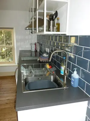 a kitchen sink with a dish rack next to it at The Old Map Shop in Wigton