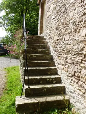 a set of stairs leading up to a stone building at The Old Map Shop in Wigton