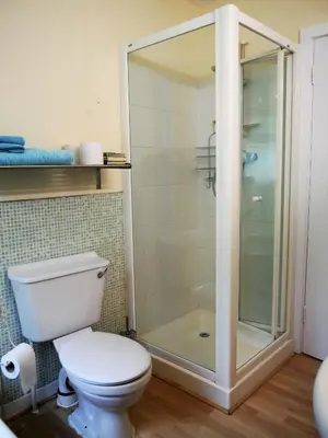a bathroom with a toilet and a glass shower at Arakhova in Kirkcudbright