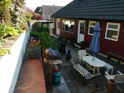 an outdoor patio with a table and an umbrella at Arakhova in Kirkcudbright