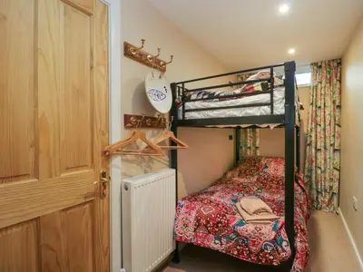 a bedroom with a bunk bed and a closet at Fellside View in Ambleside