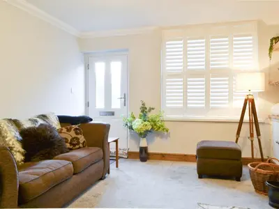 a living room with a couch and a window at Willow Cottage in Cockermouth