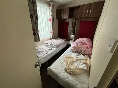 a small room with two beds and a laptop on them at Coyles retreat in Stranraer