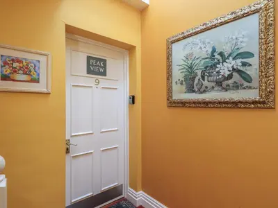 a door in a hallway with a picture on the wall at Peak View in Keswick