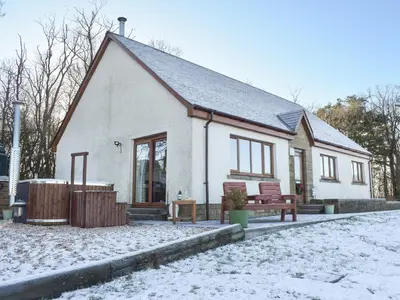 a small white house with snow on the ground at Trelaw - Uk41532 in Cumnock