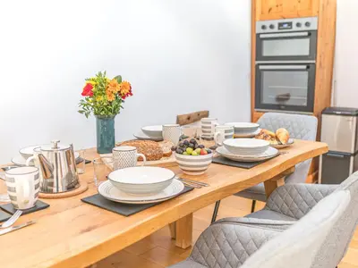 a wooden table with plates of food on it at Swallow Barn in Cockermouth
